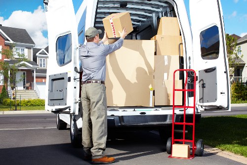 Packed boxes and furniture ready for transport in a Kew home