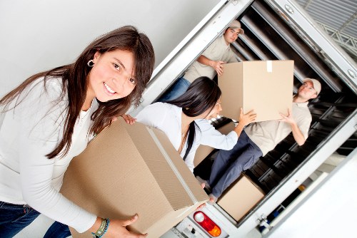 Packed moving boxes and furniture prepared for domestic removals in Kew