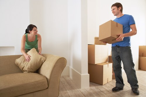 Professional movers handling furniture in a Kew home